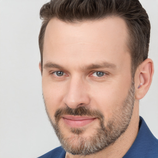 Joyful white adult male with short  brown hair and brown eyes