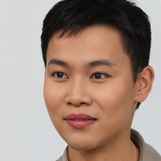 Joyful asian young-adult male with short  black hair and brown eyes