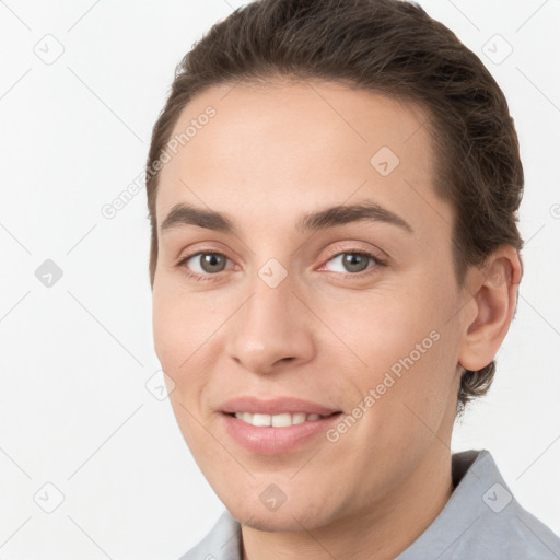 Joyful white young-adult female with short  brown hair and grey eyes