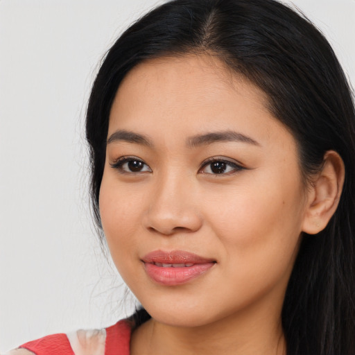Joyful latino young-adult female with long  black hair and brown eyes