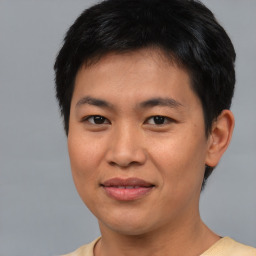 Joyful asian young-adult male with short  brown hair and brown eyes