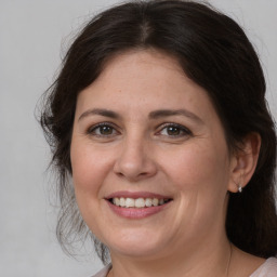 Joyful white adult female with medium  brown hair and brown eyes