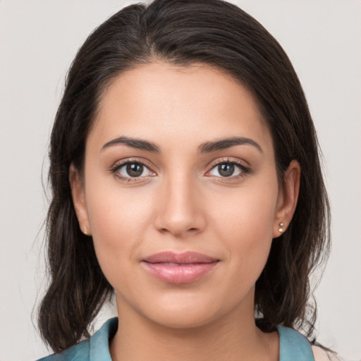 Joyful white young-adult female with medium  brown hair and brown eyes