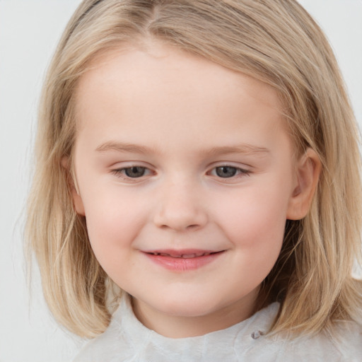 Joyful white child female with medium  brown hair and blue eyes