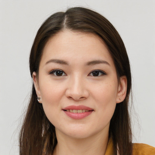 Joyful asian young-adult female with long  brown hair and brown eyes