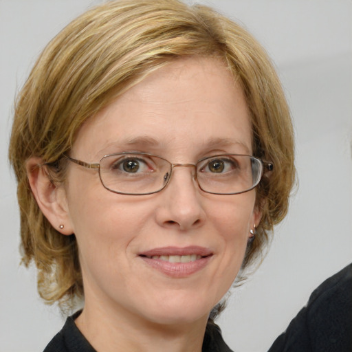 Joyful white middle-aged female with medium  brown hair and blue eyes