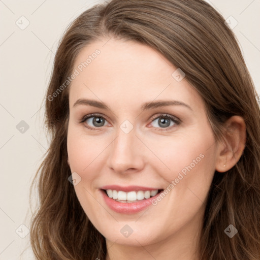 Joyful white young-adult female with long  brown hair and blue eyes