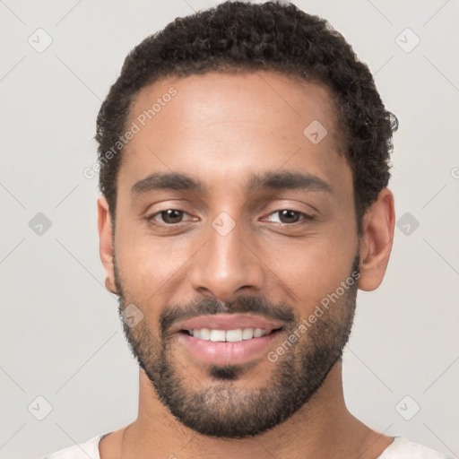 Joyful white young-adult male with short  black hair and brown eyes