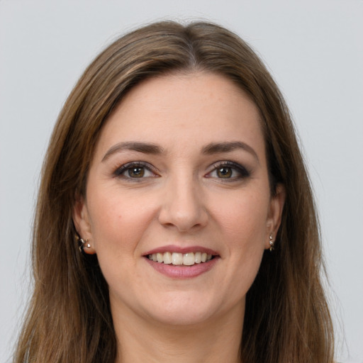 Joyful white young-adult female with long  brown hair and grey eyes