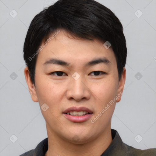 Joyful asian young-adult male with short  black hair and brown eyes