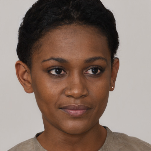 Joyful black young-adult female with short  black hair and brown eyes