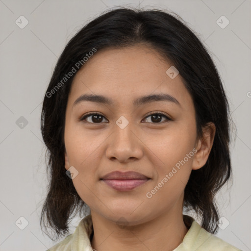 Joyful latino young-adult female with medium  brown hair and brown eyes