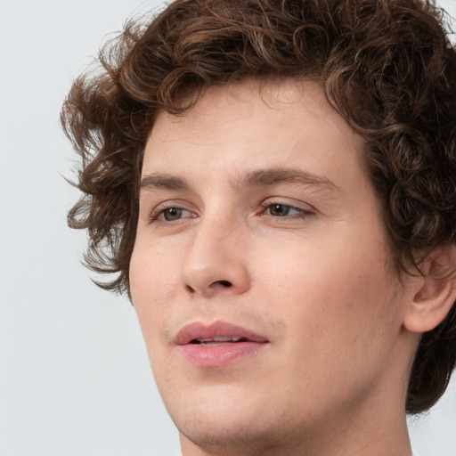 Joyful white young-adult male with medium  brown hair and brown eyes