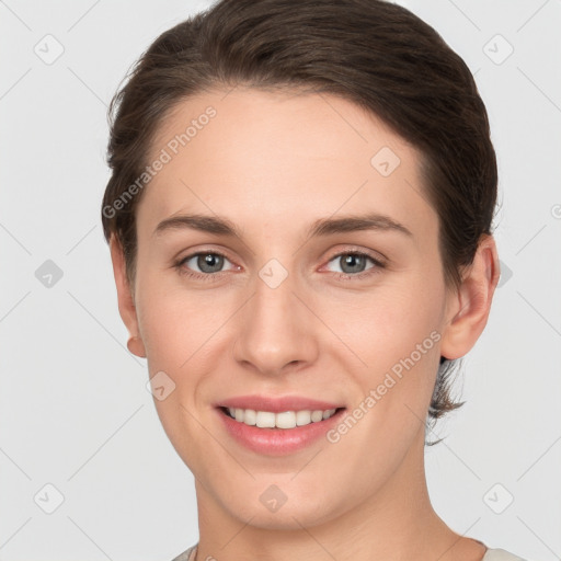 Joyful white young-adult female with short  brown hair and grey eyes