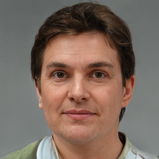 Joyful white adult male with short  brown hair and brown eyes