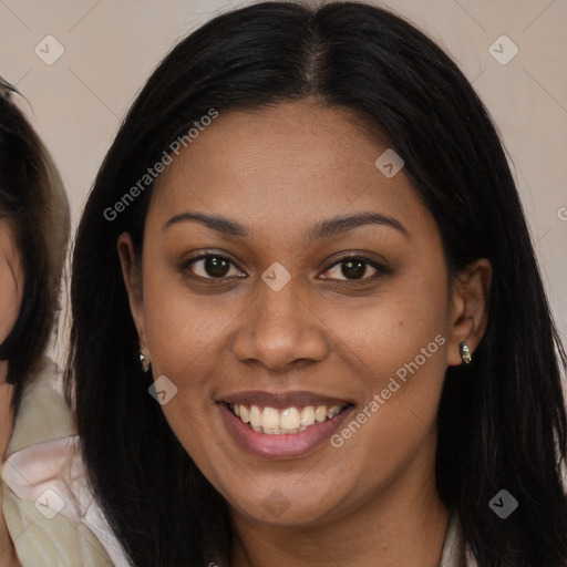 Joyful black young-adult female with long  brown hair and brown eyes