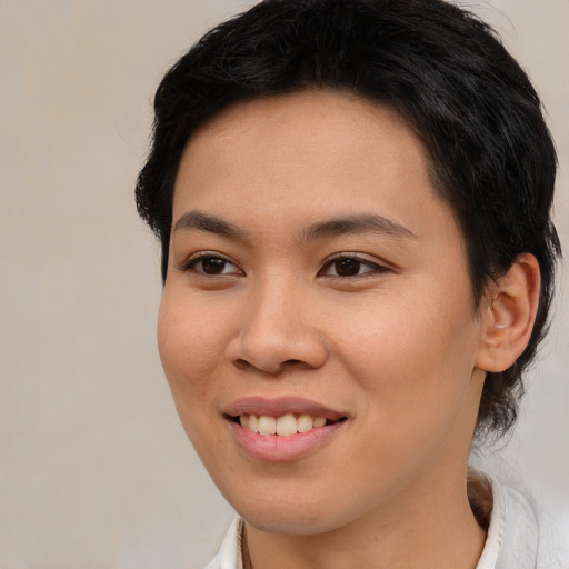Joyful asian young-adult female with medium  brown hair and brown eyes