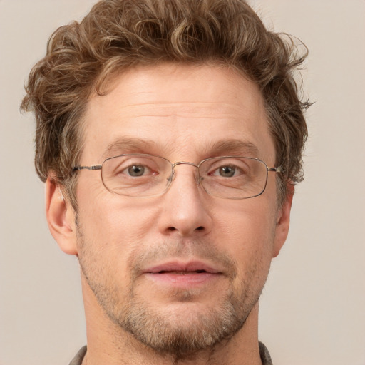 Joyful white adult male with short  brown hair and grey eyes