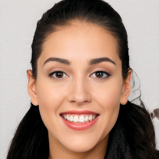 Joyful white young-adult female with long  black hair and brown eyes