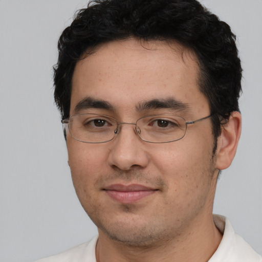Joyful white young-adult male with short  black hair and brown eyes