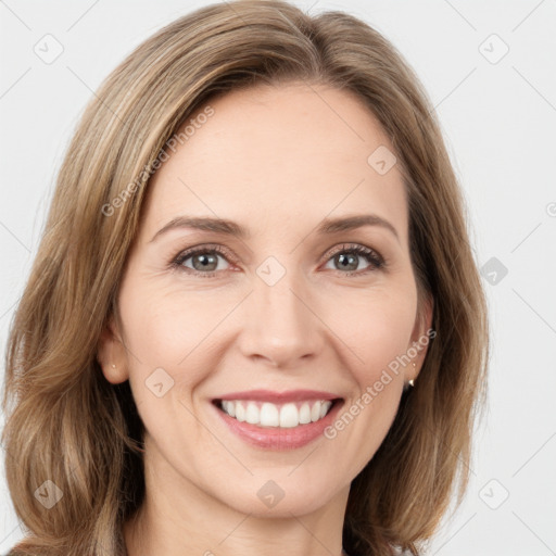 Joyful white young-adult female with long  brown hair and green eyes