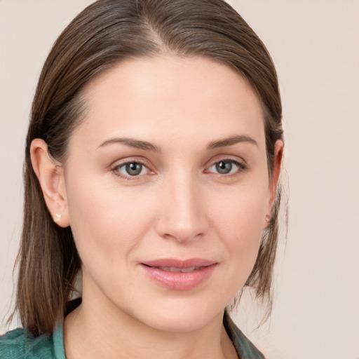 Joyful white young-adult female with medium  brown hair and grey eyes