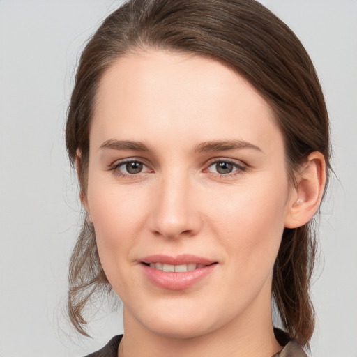 Joyful white young-adult female with medium  brown hair and brown eyes