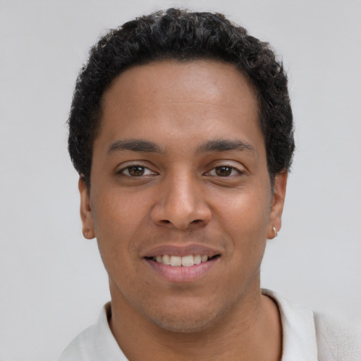 Joyful latino young-adult male with short  brown hair and brown eyes