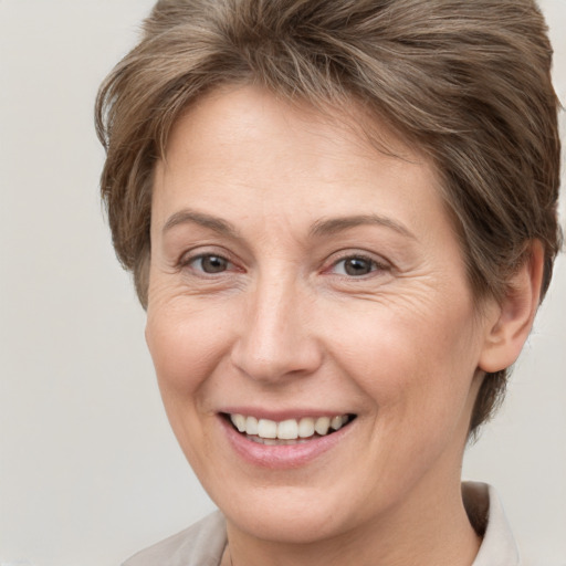 Joyful white adult female with short  brown hair and grey eyes