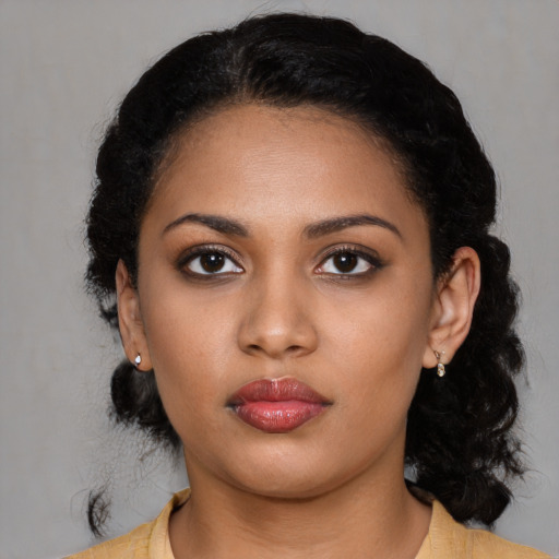 Neutral black young-adult female with medium  black hair and brown eyes