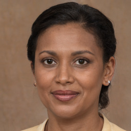 Joyful black adult female with short  brown hair and brown eyes