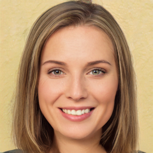 Joyful white young-adult female with long  brown hair and green eyes