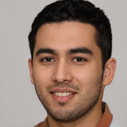 Joyful white young-adult male with short  black hair and brown eyes