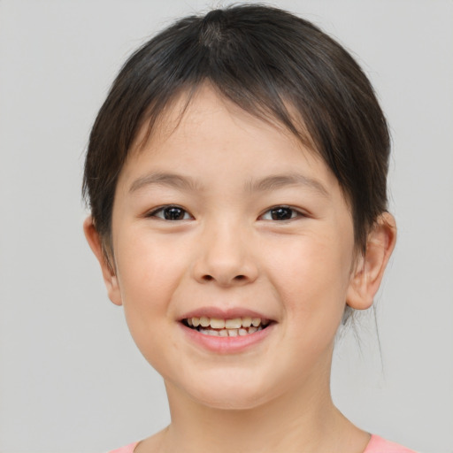 Joyful white child female with short  brown hair and brown eyes