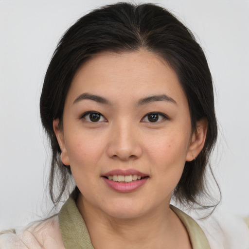 Joyful asian young-adult female with medium  brown hair and brown eyes