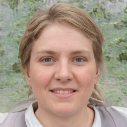 Joyful white young-adult female with medium  brown hair and blue eyes