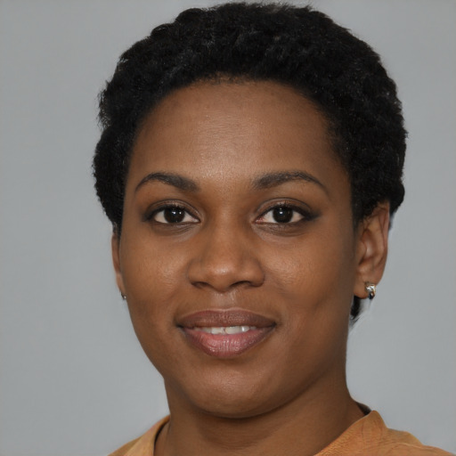 Joyful black young-adult female with short  black hair and brown eyes