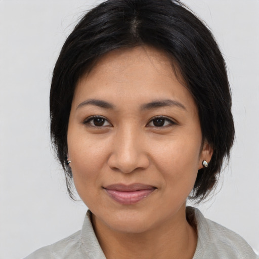 Joyful asian young-adult female with medium  black hair and brown eyes