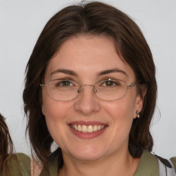 Joyful white adult female with medium  brown hair and brown eyes