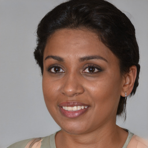 Joyful black young-adult female with medium  brown hair and brown eyes