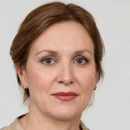 Joyful white adult female with medium  brown hair and grey eyes