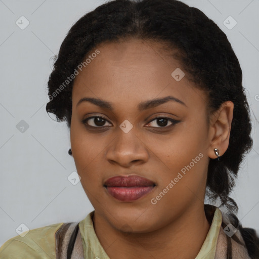 Joyful black young-adult female with long  black hair and brown eyes