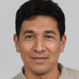 Joyful white adult male with short  black hair and brown eyes