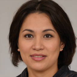 Joyful white adult female with medium  brown hair and brown eyes