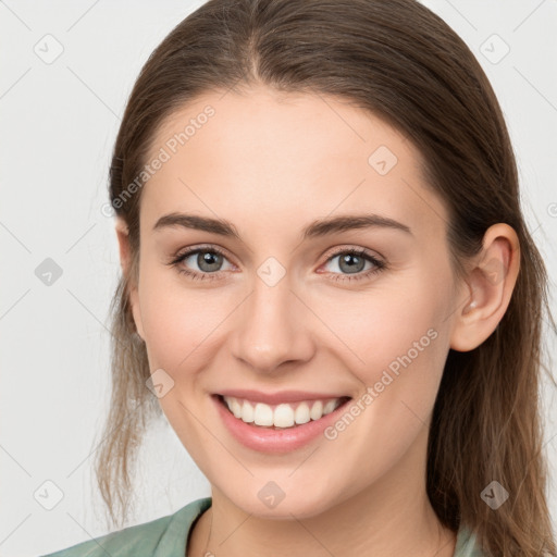 Joyful white young-adult female with long  brown hair and grey eyes