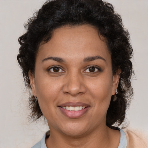 Joyful latino young-adult female with short  brown hair and brown eyes