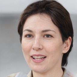 Joyful white adult female with medium  brown hair and brown eyes