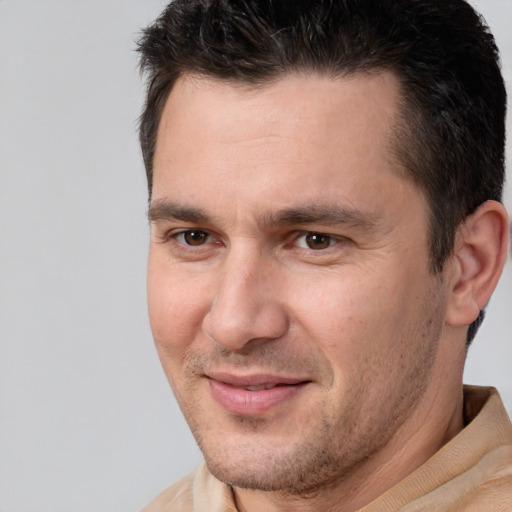 Joyful white adult male with short  brown hair and brown eyes