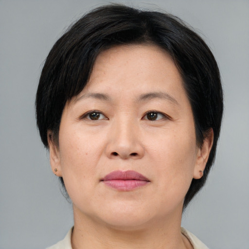 Joyful asian adult female with medium  brown hair and brown eyes