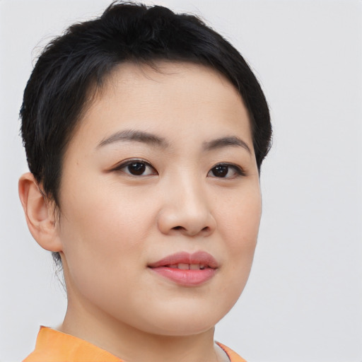 Joyful asian young-adult female with short  brown hair and brown eyes